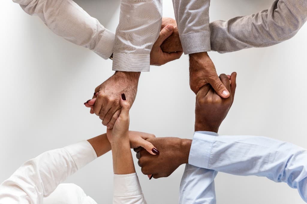 Team joining hands together