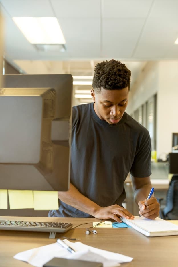 Young person writing at a desk